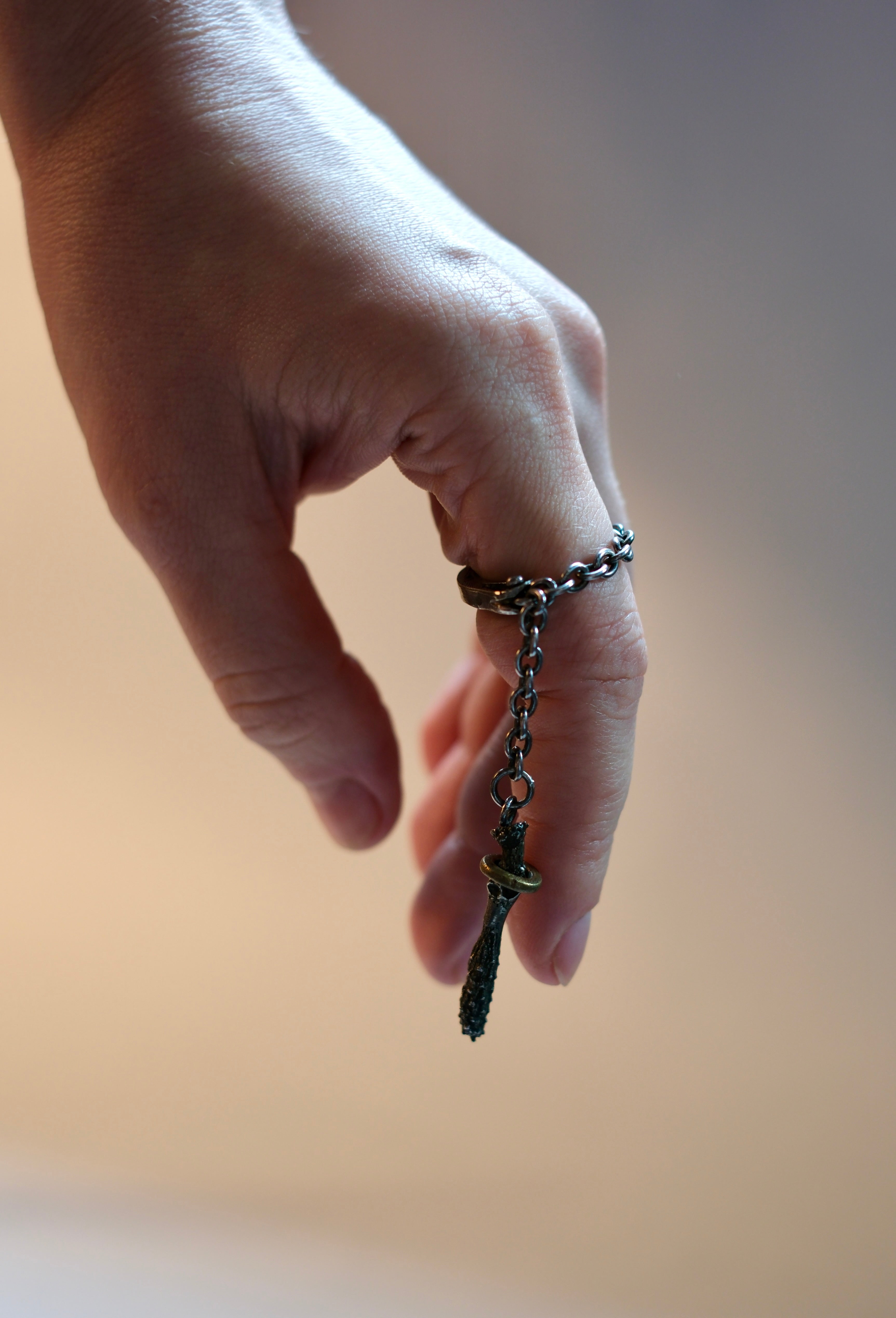 Ring with a long chaim and a charm